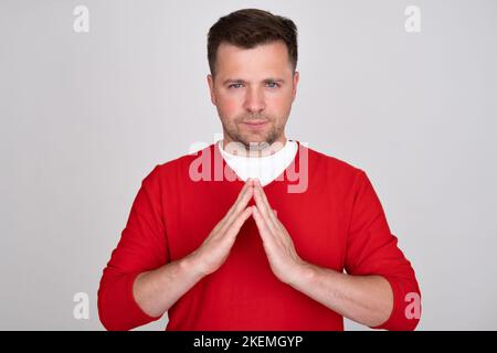 Uomo caucasico che fa gesto di casa che significa tetto con palme Foto Stock
