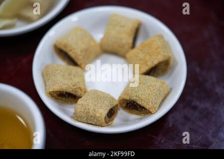 Un piatto di vecchi spuntini da dessert tradizionali di Pechino, arrotolamento di asini Foto Stock