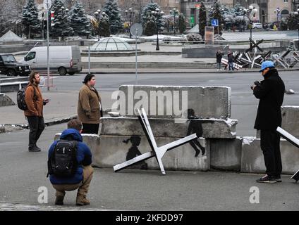 Kiev, Ucraina. 17th Nov 2022. Un uomo scatta una foto di graffiti del famoso artista di strada britannico Banksy, raffigurato su blocchi di cemento in Piazza dell'Indipendenza a Kyiv sullo sfondo dell'invasione russa dell'Ucraina. La Russia ha invaso l'Ucraina il 24 febbraio 2022, scatenando il più grande attacco militare in Europa dalla seconda guerra mondiale (Foto di Sergei Chuzavkov/SOPA Images/Sipa USA) Credit: Sipa USA/Alamy Live News Foto Stock