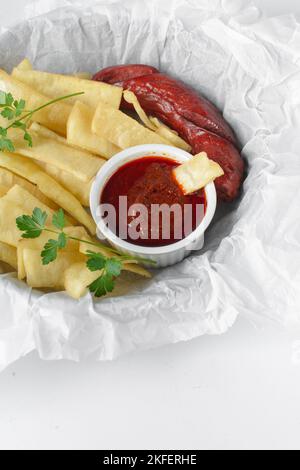 Fettine di yam fritto, salsiccia e salsa, fettine di yam fritto e stufato su carta da pergamena, patatine fritte nigeriane Foto Stock