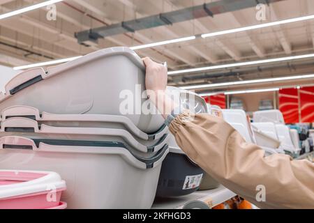 La mano della donna sceglie la cucciolata del gatto nel deposito del centro commerciale Foto Stock