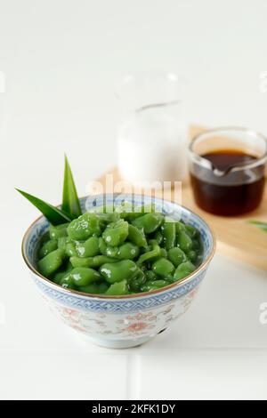 Cendol o Dawet, tradizionale dessert indonesiano a base di farina di riso e foglie di Pandan, servito freddo con liquido di zucchero di palma e latte di cocco. Foto Stock