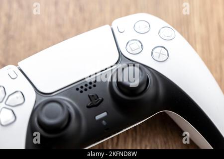 OSTRAVA, REPUBBLICA CECA - 17 MARZO 2022: Dettaglio del controller Sony DualSense utilizzato per la console di gioco PlayStation 5 su un tavolo di legno Foto Stock