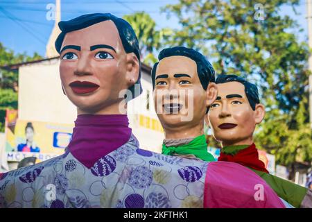 Angono, Filippine, 20/11/2022, giganti di Papier-mache si allineano sulle strade durante la grande parata del Festival di Higantes. La gente del posto festeggia il festival della città per la prima volta dopo due anni di sospensione a causa della pandemia. I giganti di Higantes o papier-mache si credevano per la prima volta che fossero stati fatti dagli agricoltori locali come una forma di protesta contro i loro proprietari terrieri durante l'era della colonizzazione spagnola. Le marionette giganti della cartapesta misurano da quattro a cinque piedi di diametro e da dieci a dodici piedi di altezza e possono controllare solo i giganti dall'interno di loro. Foto Stock