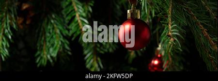 Composizione di Natale. Palla rossa su un albero di Natale primo piano Foto Stock