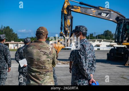 U.S. Air Force Tech. SGT. Andrew Williamson, a sinistra, tecnico di ingegneria di 18th Scquadron, ingegnere civile, parla con un membro della Japan Air Self-Defense Force, a destra, durante un'esercitazione Agile Combat Employment presso la base aerea di Kadena, Giappone, 20 ottobre 2022. La formazione bilaterale incentrata sui concetti ACE rafforza le capacità di missione su entrambi i lati dell'alleanza. Foto Stock