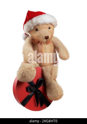 orsacchiotto in piedi accanto a un pacchetto regalo isolato su sfondo bianco Foto Stock