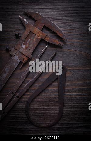 Calibro a corsoio arrugginito su legno d'epoca. Foto Stock