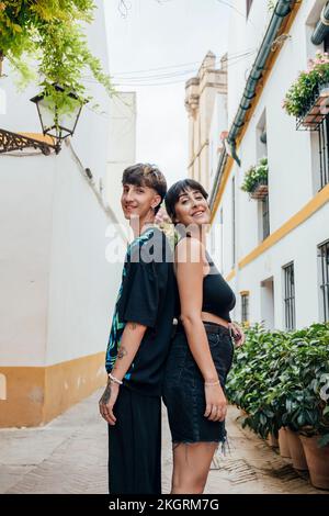 Giovane coppia sorridente che si alza di nuovo a ritroso sul sentiero Foto Stock