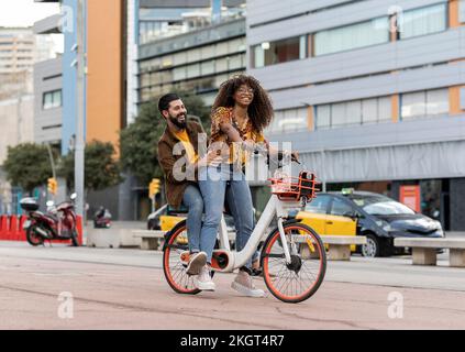 Felice ragazzo godendo con la ragazza in bicicletta a cavallo sul sentiero Foto Stock