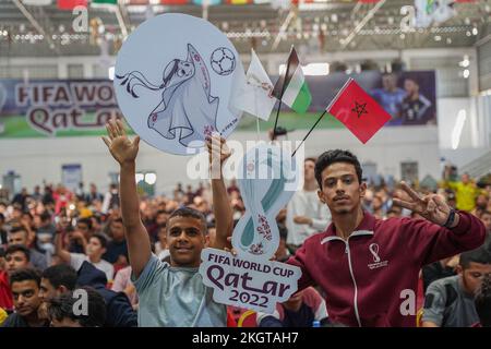 Gaza, Palestina, Stati Uniti. 23rd Nov 2022. (INT) i palestinesi sostengono la squadra di calcio marocchina durante la partita contro la Croazia nella Coppa del mondo FIFA in Qatar. 23 novembre 2022, Gaza, Palestina: Centinaia di palestinesi nella striscia di Gaza sono stati nella Saad Sail Hall della striscia di Gaza per sostenere e incoraggiare la squadra arabo-marocchina a giocare contro la Croazia durante la Coppa del mondo di calcio FIFA 2022 in Qatar. Il gioco si è concluso tra il 0 e il 0, un pareggio e il vice ambasciatore Qatari Khaled al-Hardan hanno condiviso l'atmosfera entusiastica con i fan mentre guardavano la partita. Credit: Saher Elghorra/Thenews2 (Credit Image: © Sahe Foto Stock