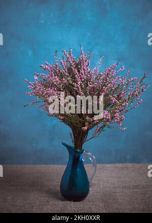 Bouquet di erica in vaso blu. Natura morta classica. Foto Stock