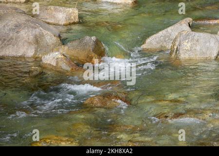 Ruscello di montagna che scorre tra rocce di fiume ruvide su un sentiero diagonale nelle Cascades di Washington Foto Stock