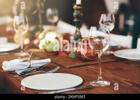 Tavolo, bicchiere di vino e piatto per le feste, bere e festeggiare con sfondo sfocato. Cene raffinate, feste e bicchiere di vino a festa Foto Stock