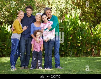 Attaccarsi insieme come una famiglia. una famiglia in posa per una foto. Foto Stock