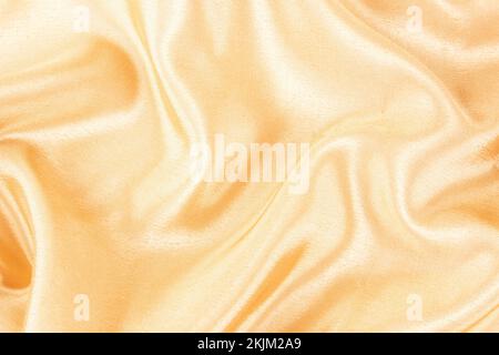 Liscio elegante colore oro seta o satinato tessuto di lusso può utilizzare come sfondo di nozze. Design di sfondo lussuoso Foto Stock