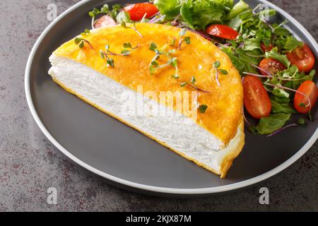 Uova strapazzate omelette ricetta madam Poulard primo piano sul piatto sul tavolo. Orizzontale Foto Stock