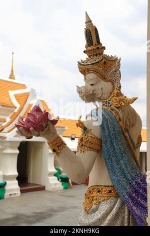 Una statua di bianco perla della mitica dea tailandese che tiene fiori di loto al Wat Pariwat Ratchasongkram. Un tempio con arte contemporanea tailandese buddish Foto Stock