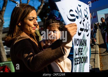 Reno, Stati Uniti. 27th Nov 2022. Una donna e un bambino partecipano a una protesta per sostenere la gente in Iran. I locali si riuniscono per esprimere il loro sostegno alle proteste in corso in Iran e alla rabbia nei confronti del governo iraniano. (Foto di Ty o'Neil/SOPA Images/Sipa USA) Credit: Sipa USA/Alamy Live News Foto Stock