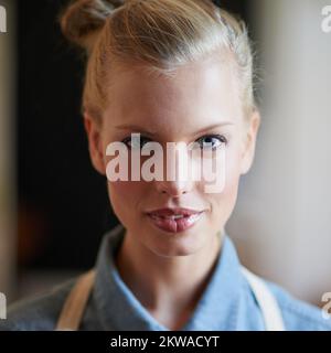 SA come preparare la migliore tazza di caffè. Una giovane donna che indossa un grembiule. Foto Stock