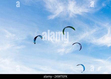 Persone che praticano il kitesurf sulla spiaggia di Los Caños de Meja, vicino al faro di Trafalgar, Barbate, Cadice Foto Stock