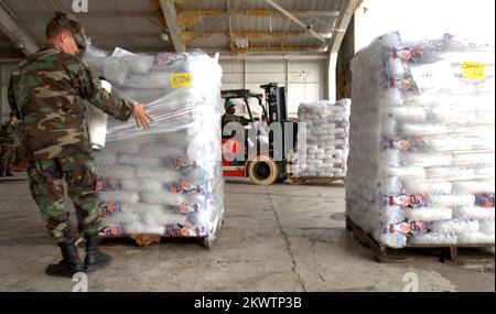 Hurricane Wilma, Homestead, FL, 30 ottobre 2005, National Guardsman, Steven Laughlin di Ocala, avvolge pallet di ghiaccio in un appendiabiti presso la base dell'aeronautica che viene utilizzata come area di sosta per la distribuzione di acqua e ghiaccio per le aree colpite dall'uragano Wilma. Jocelyn Augustno/FEMA.. Fotografie relative a disastri e programmi, attività e funzionari di gestione delle emergenze Foto Stock