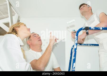 apprendista maschile dipingendo un soffitto Foto Stock