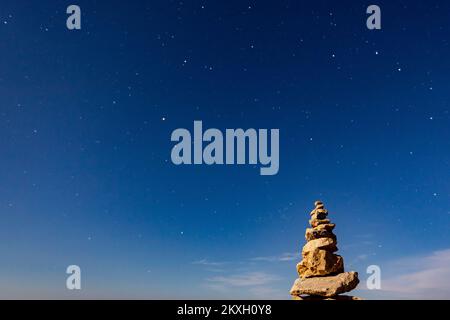 Vista del cielo notturno e sculture di pietre impilate, sull'isola di Vir, Croazia, il 2 agosto 2020. L'isola di Vir è una delle 300 isole e isolette dell'arcipelago di Zara, una delle 1186 isole e isolette nell'Adriatico croato. Passato nel mare di Vir nella parte settentrionale della Dalmazia. Foto: Davor Puklavec/PIXSELL Foto Stock