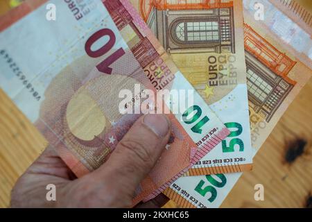 fatture in euro in mano per pagare le merci Foto Stock