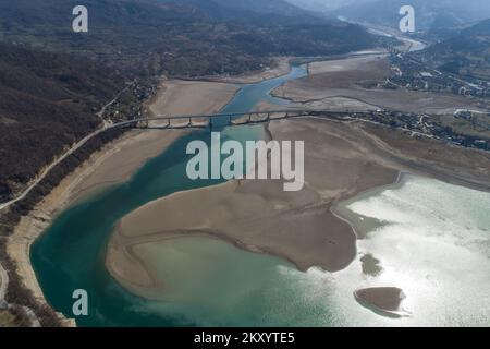 Il lago Jablanicko può essere visto nella foto a Liscici, Bosnia-Erzegovina il 21 marzo 2022. Dopo che il lago Jablanicko quasi completamente asciugato alcune settimane fa, oggi la situazione è un po 'meglio, l'acqua è versato nel letto del fiume. All'inizio del secondo mese, l'acqua del lago di Jablanica si è ritirata, lasciando dietro scene inquietanti di depressioni del lago esposte. Foto: Armin Durgut/PIXSELL Foto Stock