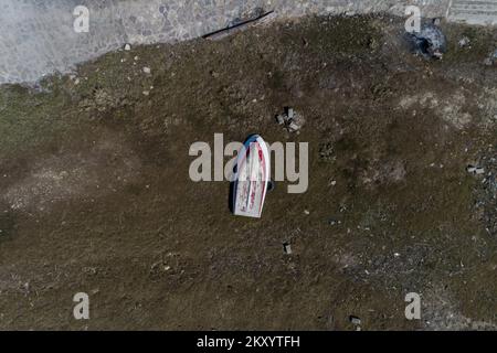 Il lago Jablanicko può essere visto nella foto a Liscici, Bosnia-Erzegovina il 21 marzo 2022. Dopo che il lago Jablanicko quasi completamente asciugato alcune settimane fa, oggi la situazione è un po 'meglio, l'acqua è versato nel letto del fiume. All'inizio del secondo mese, l'acqua del lago di Jablanica si è ritirata, lasciando dietro scene inquietanti di depressioni del lago esposte. Foto: Armin Durgut/PIXSELL Foto Stock