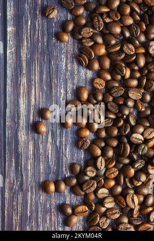 Caffè in grani versato sul tavolo. Foto Stock