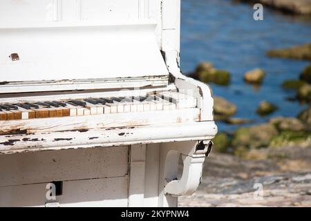 Un vecchio piano bianco sulla spiaggia, un vecchio pianoforte bianco sulla spiaggia Foto Stock