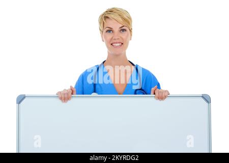Il vostro messaggio su una grande lavagna bianca. Un giovane medico che tiene in mano una lavagna bianca. Foto Stock