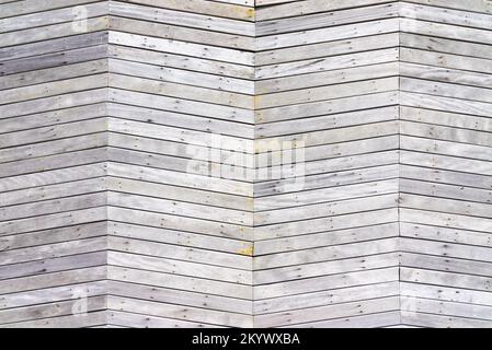 Parete di legno chiaro con motivo a chevron texture sfondo Foto Stock