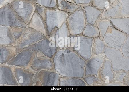 Struttura di un vecchio muro fatto di grandi pietre di fiume Foto Stock
