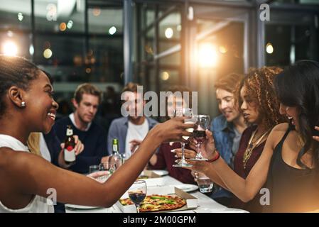 Amici, festa e brindisi con vino per festeggiare, festa di Capodanno e felice di ritrovo sociale e amicizia. Uomini, donne e cibo con Foto Stock