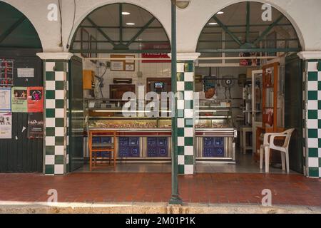 Macellaio nel mercato coperto nella città spagnola di Ciutadella, Minorca, isole Baleari, Spagna. Foto Stock