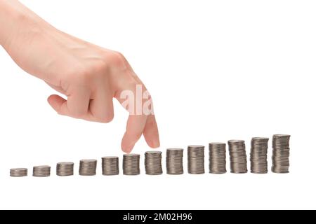 Diventare ricchi. Donna dita di mano che camminano sulle monete. Concetto aziendale. Foto Stock