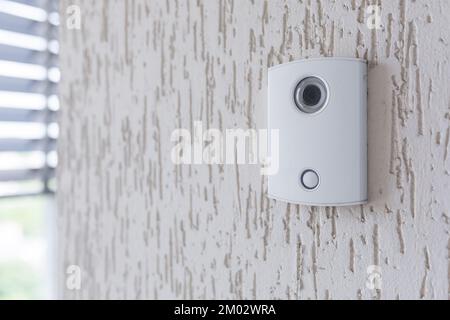 Un campanello elettronico bianco in entrata con una telecamera sulla parete dell'edificio, ufficio. Foto Stock