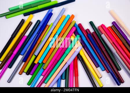 Un set di penne multicolore in fila, arcobaleno su uno sfondo bianco chiaro per striscioni. Tracciatura di marcatori, matite, inchiostro, strumenti per artisti, creat Foto Stock