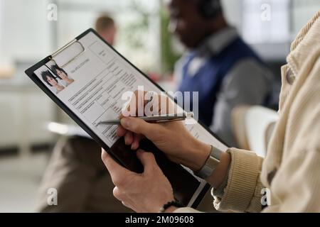 Ritratto di una donna matura che lavora in un ufficio di servizi e utilizza un computer portatile mentre si consulta un cliente maschile Foto Stock