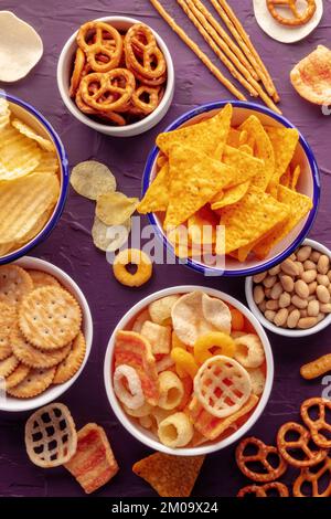 Spuntini salati, shot dall'alto. Una tavola di antipasti assortiti in ciotole, un piatto piatto di cibo per feste Foto Stock