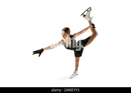 Studio shot di bella figura femminile skater in nero festive stage vestito pratica elementi base di breve programma. Sport invernali, flessibilità Foto Stock