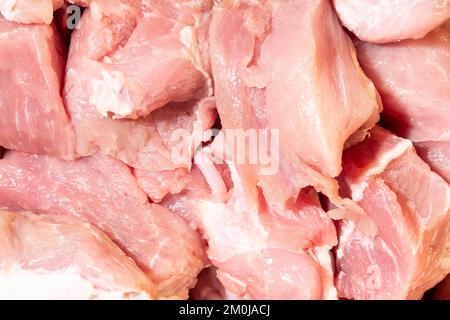 Struttura di carne cruda come sfondo. Primo piano di carne cruda per stufato. Foto macro. Carne cruda - maiale. Foto Stock