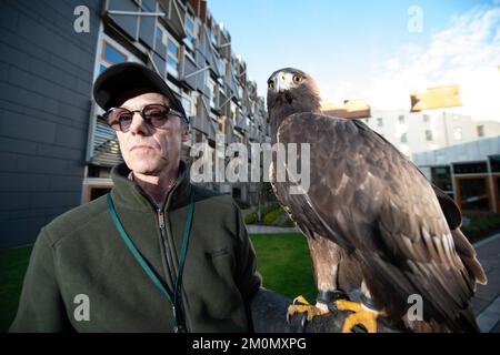 Edimburgo, Scozia, Regno Unito. 7 dicembre 2022. NELLA FOTO: Barry Blyther con Stanley l'Aquila d'oro. La commissione per la partecipazione dei cittadini e le petizioni pubbliche prenderà le prove del firmatario prima della giornata per comprendere meglio l'impatto della legislazione del 2020 sulla falconeria in Scozia e se vi sono state conseguenze involontarie. Il petitioner Barry Blyther, Roxanne Blyther e Stanley l'aquila d'oro. Il Comitato dovrà inoltre prendere atto del Ministro dell'ambiente, della biodiversità e della riforma fondiaria e di NatureScot il 21st dicembre 2022. Credit: Colin D Fisher Foto Stock