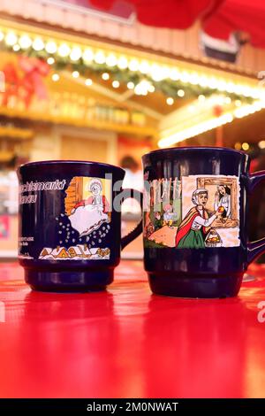 Hanau, Germania - 15 dicembre 2019: Due tazze su un tavolo rosso ad un mercato di Natale ad Hanau, Germania. Foto Stock
