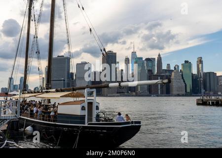 Pilot, ormeggiato a Brooklyn Heights, è un bar stagionale all'aperto con ostriche a bordo di una delle barche a vela in legno più pregiate d'America. Brooklyn, NY, USA. Foto Stock