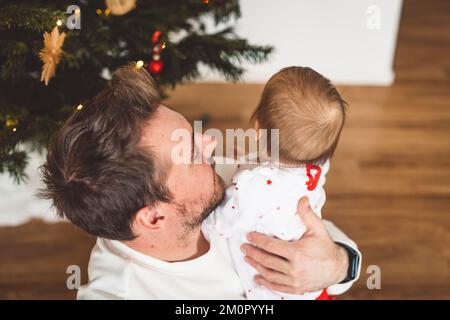 Vista dall'alto verso il basso a papà, giovane uomo che tiene la sua bambina Foto Stock