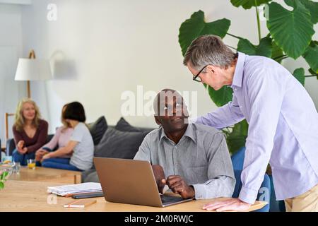 Two male business partners working together from home Foto Stock